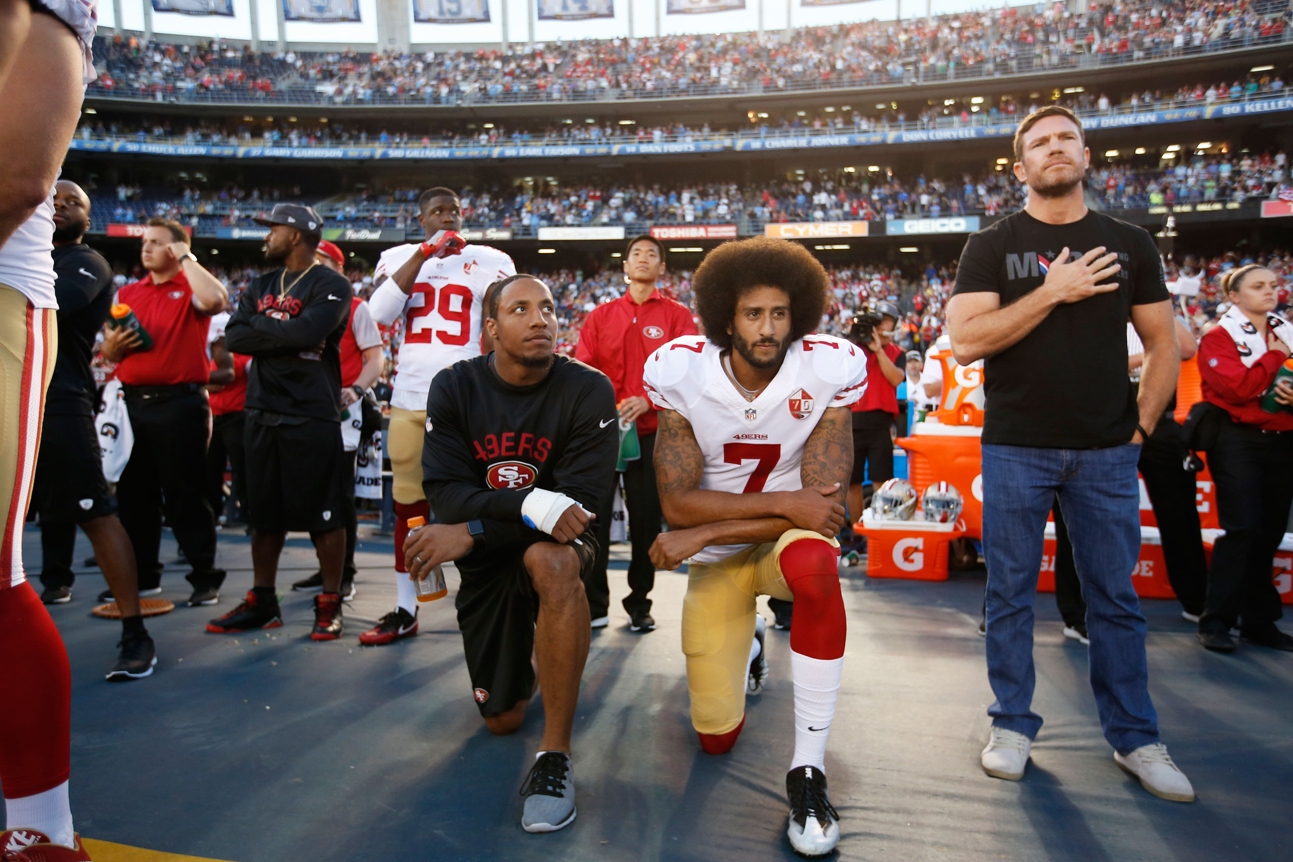 san-francisco-49ers-quarterback-colin-kapernick-neals-during-national-anthem.jpg